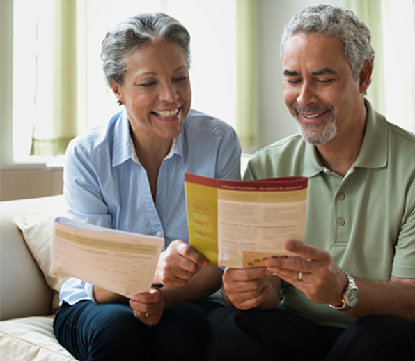 Smiling senior couple looking at brochure
